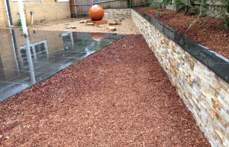 Brick fancy wall pebbles water feature landscaping